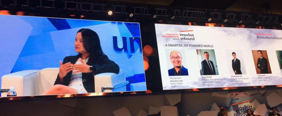 Joanna speaking on stage at Innovfest Unbound, Singapore